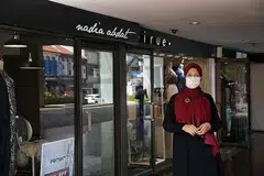TERJEJAS: Cik Nadiah Abdat di luar tiga kedainya yang terpaksa ditutup akibat langkah pemutus litar. Beliau yang menjual produknya dalam talian juga menyatakan penjualan agak lemah. - Foto Ihsan NADIAH ABDAT