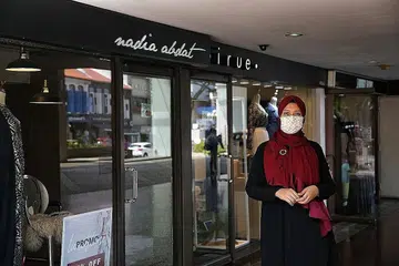 TERJEJAS: Cik Nadiah Abdat di luar tiga kedainya yang terpaksa ditutup akibat langkah pemutus litar. Beliau yang menjual produknya dalam talian juga menyatakan penjualan agak lemah. - Foto Ihsan NADIAH ABDAT