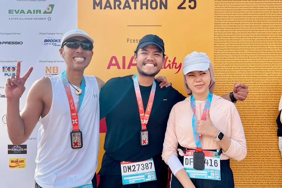 Encik Muhammad Adry Fazmi (kiri) bersama Encik Ammar Naim (tengah) dan tunang Encik Ammar, Cik Aida Shafit (kanan) bergambar sama selepas tamat separuh maraton sejauh 21 kilometer.