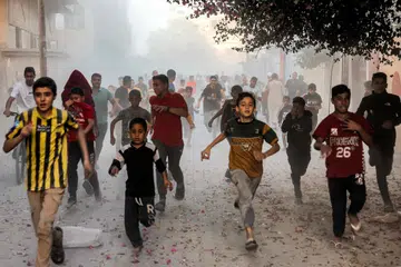 DERITA PERANG: Kanak-kanak Palestin bertempiaran lari bagi menyelamatkan diri ketika tentera Israel melakukan pengeboman di Rafah, selatan Gaza pada Isnin.