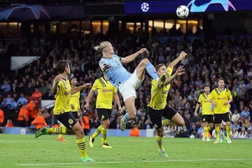 GOL MENAKJUBKAN: Haaland (jersi biru) menjaringkan gol pada minit ke-84 untuk memberi City kemenangan ke atas bekas kelabnya, Dortmund. - Foto REUTERS