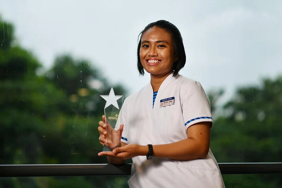 JALANKAN TANGGUNGJAWAB: Cik Rafikah Sawal menerima Anugerah Superhero sebagai pengiktirafan atas usahanya membantu pekerja migran ketika bertugas. - Foto BH oleh CHONG JUN LIANG