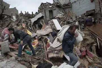 KEHIDUPAN TERJEJAS TERUK: Penduduk di Sankhu yang terletak di luar ibu kota Kathmandu semalam mencari barangan yang boleh diselamatkan di bawah puing runtuhan. - Foto AFP