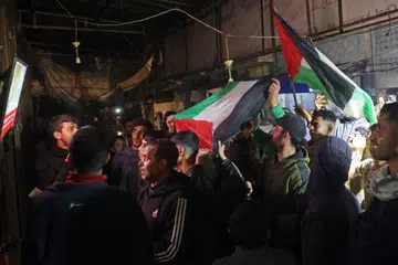 Penduduk Gaza meraikan di sepanjang jalan di Deir el-Balah, di Gaza Tengah, pada 15 Januari 2025, di tengah-tengah perang yang masih berterusan antara Israel dan Hamas di wilayah Palestin. Sekumpulan penduduk Gaza melaungkan slogan dan berpelukan pada 15 Januari apabila berita mengenai perjanjian gencatan senjata dan pembebasan tebusan yang dicapai antara Israel dan Hamas mula tersebar. Perjanjian itu bertujuan untuk mengakhiri lebih daripada 15 bulan peperangan di wilayah Palestin.