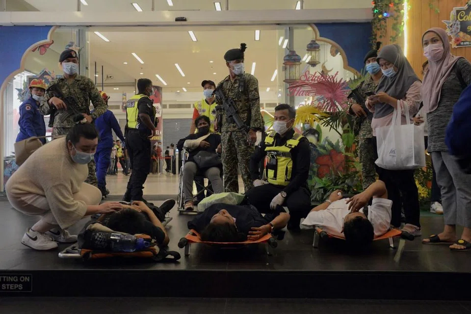 DIBERI BANTUAN: Sebilangan penumpang sedang dibaringkan di atas tandu (gambar) di stesen KLCC selepas diberi rawatan dan menanti untuk dibawa ke beberapa hospital berdekatan. Dilaporkan seramai 213 orang cedera, 47 daripadanya parah. - Foto EPA-EFE