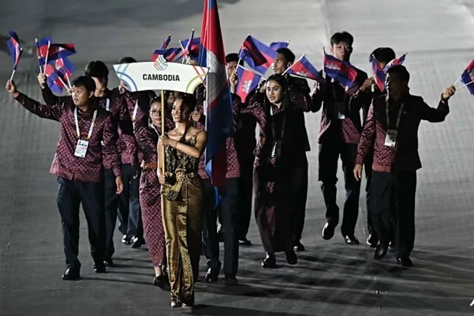 Anggota kontinjen Kemboja melambaikan bendera negara mereka ketika menyertai perarakan atlet sempena majlis pembukaan Sukan SEA ke-33 di Stadium Nasional Rajamangala, Bangkok, pada 9 Disember 2025.