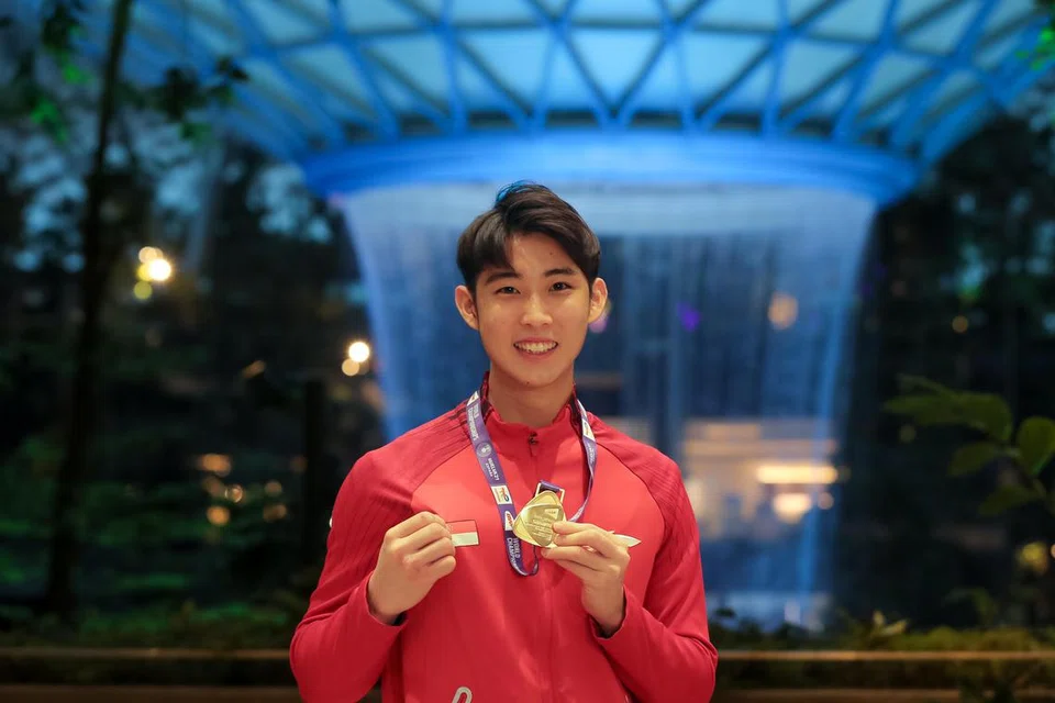 Dengan pingat emasnya, pemuda berusia 24 tahun itu tersenyum lebar sambil melambai ketika melangkah masuk ke terminal ketibaan di Terminal 1 Lapangan Terbang Changi, disambut dengan sorakan dan tepukan gemuruh daripada rakyat Singapura yang berkumpul untuk menyaksikan wira baru Singapura itu.