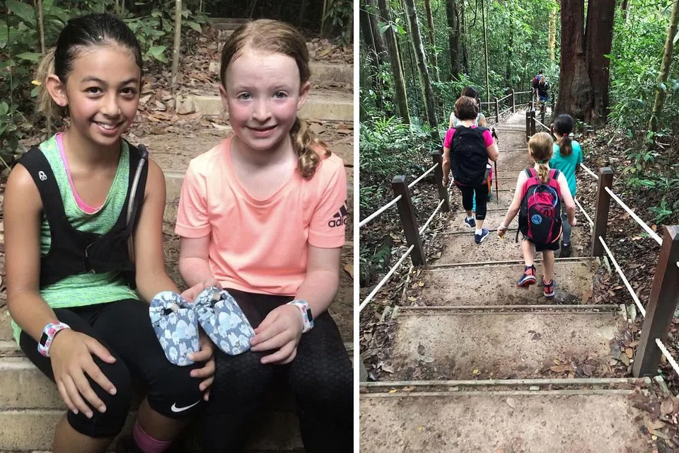 DEMI MEMBANTU KANAK-KANAK LAIN: Zoe (kiri) dan Anya berihat seketika semasa berlatih di Bukit Timah. - Foto-foto AMAZING TREKKERS CLUB