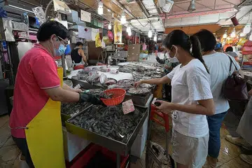 TIDAK SIBUK: Pasar Chong Pang yang kurang sibuk berbanding biasa dilihat setelah pembukaan semulanya semalam. - Foto-foto BH oleh NG SOR LUAN