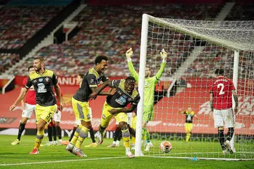 GOL PENTING: Pemain gantian Southampton Michael Obafemi (tengah) menjaringkan gol penyamaan 2-2 pada minit ke-96 di Old Trafford untuk memberi pasukannya satu mata daripada perlawanan itu, dan menghalang Manchester United naik ke tangga empat teratas EPL. Pengurus United Solskjaer, kelihatan menyambut penjaga gol David de Gea, berkata ia "waktu paling buruk untuk memberi pasukan lawan peluang menjaringkan gol". - Foto EPA-EFE