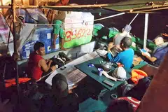 BERJAYA DISELAMATKAN: Anak kapal Samudera Indah yang berjaya diselamatkan, duduk di atas kapal Sunlight Poseidon. - Foto MOHAMED SHARJAHAN