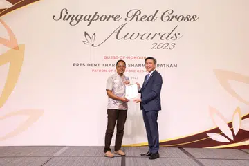 TERIMA ANUGERAH: Encik Mohamad Rozaini Mohamed Jelani, 54 tahun (kiri), menerima Anugerah Kepujian Palang Merah Singapura (SRC) pada 3 Oktober, daripada Encik Tan Kai Hoe, pengerusi SRC. 
