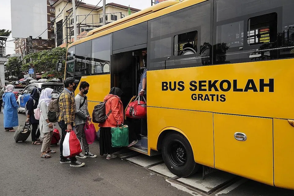 PESAKIT DIPINDAHKAN UNTUK RAWATAN: Mereka yang dijangkiti Covid-19 beratur untuk menaiki bas yang membawa mereka dari pusat kesihatan ke Hospital Kecemasan Kampong Atlet di Jakarta, Selasa lalu. - Foto EPA-EFE