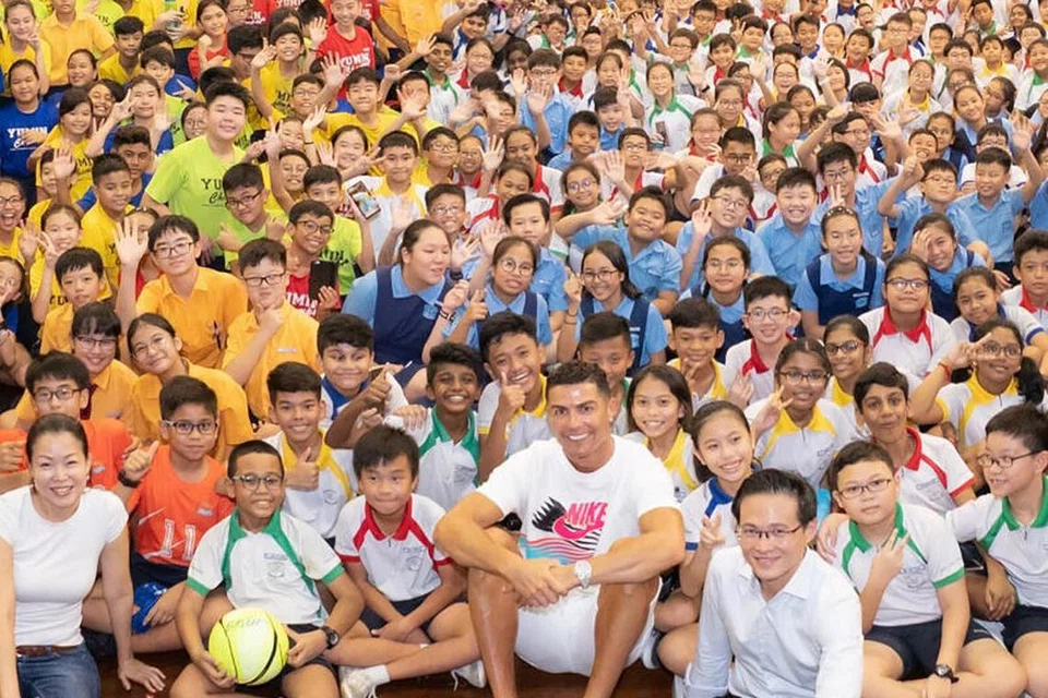 BERI INSPIRASI: Cristiano Ronaldo (tengah) melawat Sekolah Rendah Yumin di Tampines pada 2019 bagi menyokong Biasiswa Yayasan Olimpik Singapura-Peter Lim. 
