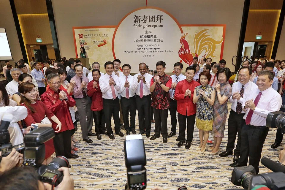 MENGHADAPI DUNIA PENUH CABARAN: Encik K. Shanmugam (barisan depan, tujuh dari kanan) berkata masyarakat yang berpegang teguh pada budaya lebih yakin dalam menangani isu dunia yang pelbagai pada masa ini. - Foto THE STRAITS TIMES