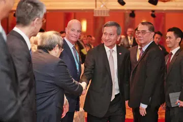 INTERAKSI BERSAMA: Menteri Ehwal Luar, Dr Vivian Balakrishnan (berjabat tangan) beramah tamah dengan para hadirin di Program Asia-Pasifik ke-13 bagi Pegawai Keselamatan Nasional Kanan yang diadakan di Hotel Marina Mandarin Singapore baru-baru ini. Bersamanya ialah Timbalan Pengerusi Eksekutif Sekolah Pengajian Antarabangsa S. Rajaratnam (RSIS), Encik Ong Keng Yong (dua dari kanan). - Foto KELVIN CHNG
