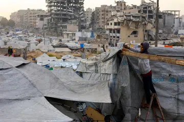 Seorang penduduk Palestin yang kehilangan tempat tinggal membaiki khemahnya ketika gencatan senjata antara Israel dan Hamas di Gaza City, 4 November 2025.
