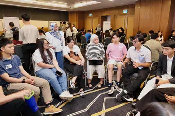 Menteri Negara Pembangunan Digital dan Penerangan, Cik Rahayu Mahzam (berdiri) mendengarkan hujah belia yang menyertai sesi perbincangan mengenai keselamatan dalam talian pada 4 Julai.