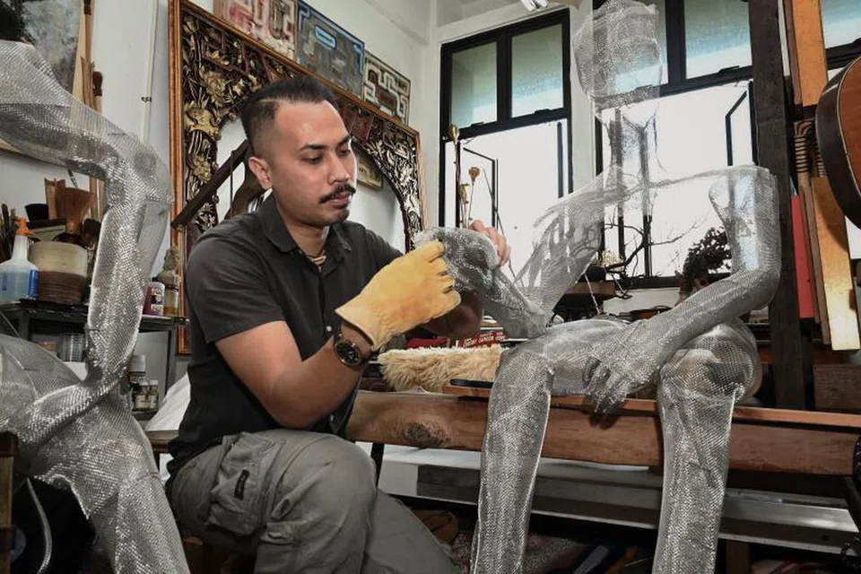 Encik Muhammad Nhawfal Juma’at dikelilingi karya seninya di studio temannya di Clementi Street 12.