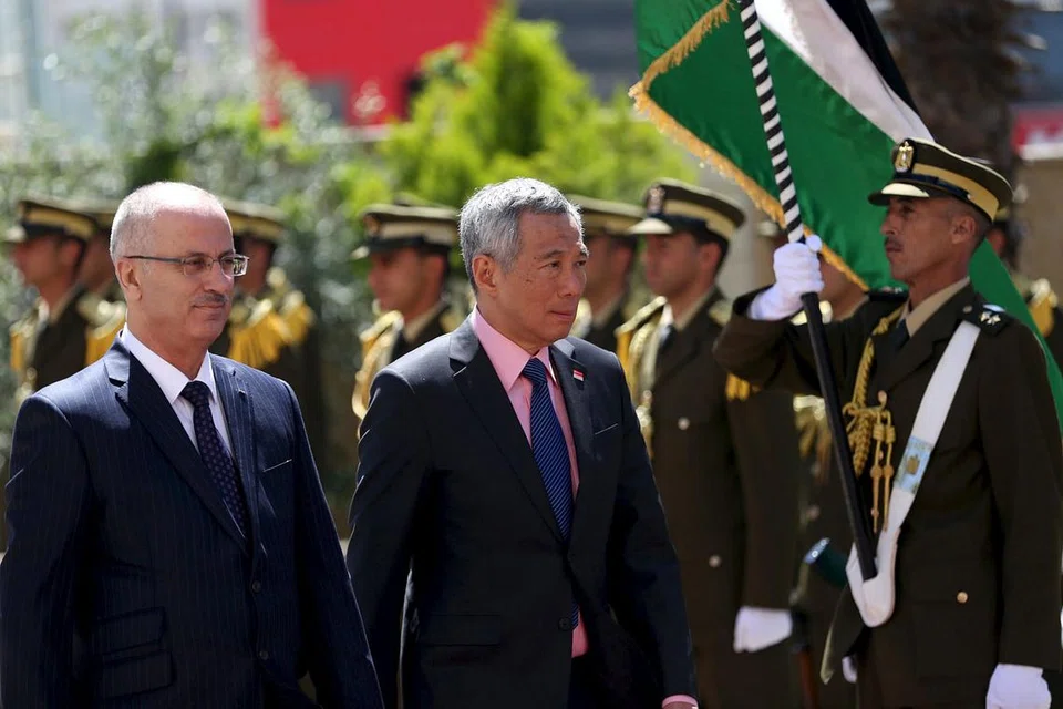 KAWALAN KEHORMATAN BAGI PM: Perdana Menteri Palestin, Encik Rami Hamdallah (kiri), dan Perdana Menteri Lee Hsien Loong memeriksa kawalan kehormatan Palestin setibanya beliau di Ramallah. - Foto REUTERS