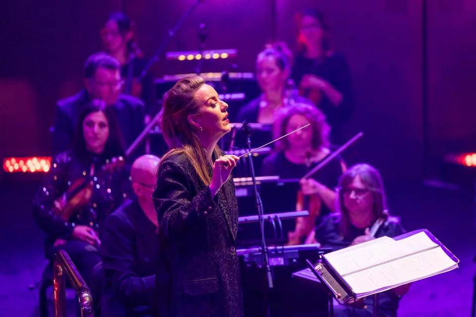 Pemimpin Orkestra Base Philharmonic, Jessica Gethin (tengah), akan menerajui konsert, ‘Hopelessly Devoted’, yang memberi sanjungan kepada penyanyi bersuara emas, Olivia Newton-John.