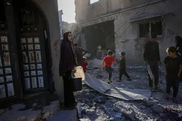 Penduduk Gaza memeriksa tapak serangan Israel di Jabalia di tengah Jaluran Gaza, pada 30 Mei, di tengah-tengah perang antara Israel dengan kumpulan militan Hamas.