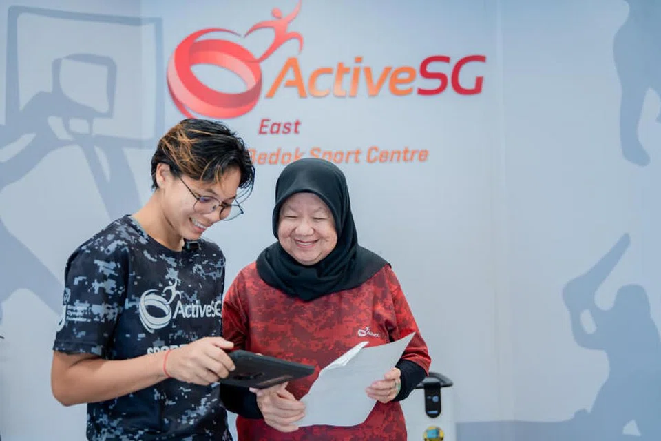 IMBANG MASA: Farhanah (kiri) bertugas sebagai pegawai perhubungan tamu di Pusat Sukan Bedok ActiveSG. 