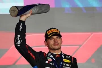 Pemandu Red Bull Racing, Max Verstappen dari Belanda, menjulang trofi pemenang Grand Prix Formula 1 Qatar di Litar Antarabangsa Lusail di Lusail, Qatar, pada 1 Disember.