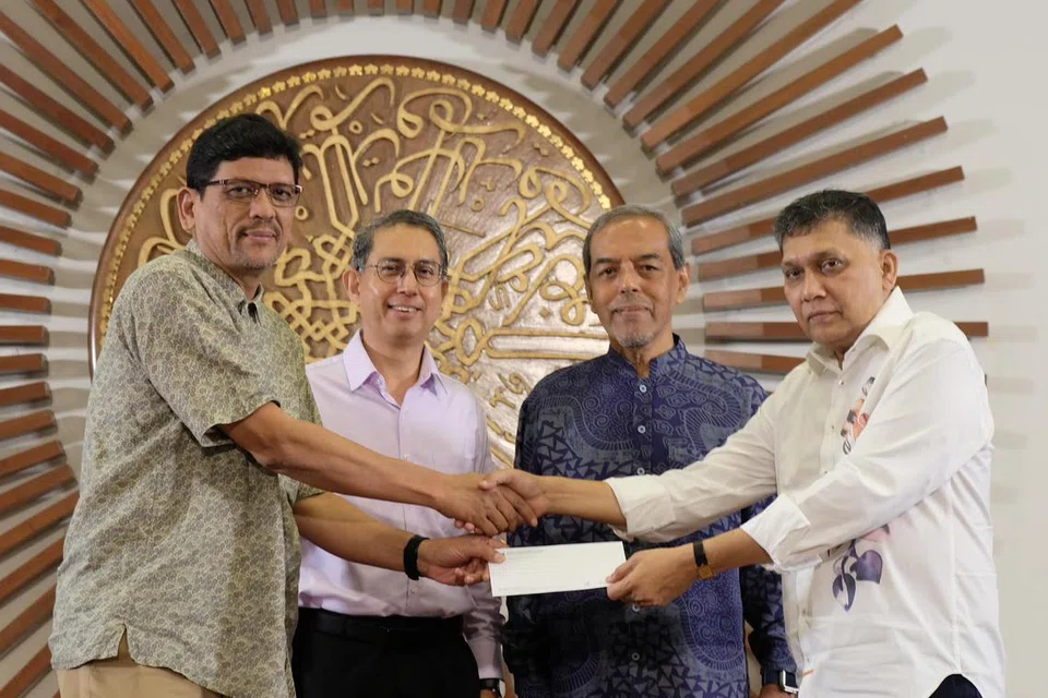 Pengasas dan Ketua Pegawai Eksekutif (CEO) MES Group, Encik Mohamed Abdul Jaleel (kanan), menyerahkan cek kepada CEO RLAF, Encik Adnan Abdul Hamid (kiri), sambil disaksikan Menteri Negara (Ehwal Dalam Negeri merangkap Pembangunan Negara), Profesor Madya Dr Muhammad Faishal Ibrahim (dua dari kiri), dan Pengerusi RLAF, Encik Abdul Razak Maricar, sewaktu Simposium India Muslim pada 21 September.