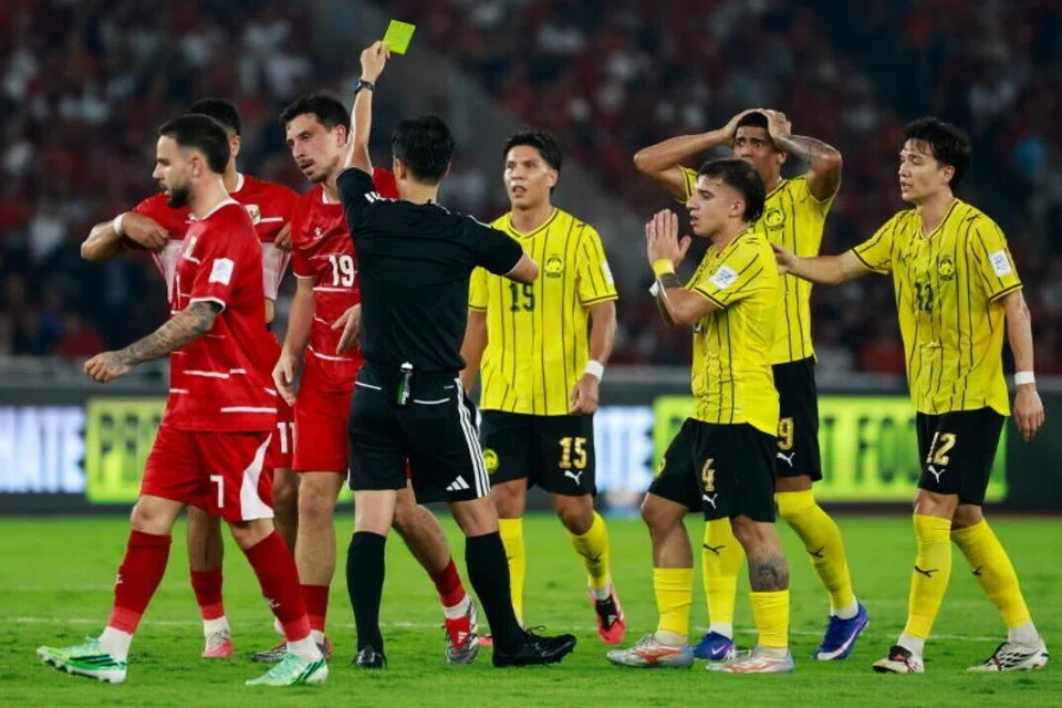 Pemain tengah Indonesia, Thom Haye (dua dari kiri) dilayangkan kad kuning oleh pengadil Korea Selatan, Ko Hyung-jin, dalam perlawanan bola sepak Piala Asean Persekutuan Persatuan Bola Sepak Antarabangsa (Fifa) 2026 antara Malaysia dan Indonesia di Stadium Gelora Bung Karno, Jakarta, Indonesia, pada 28 September 2026.