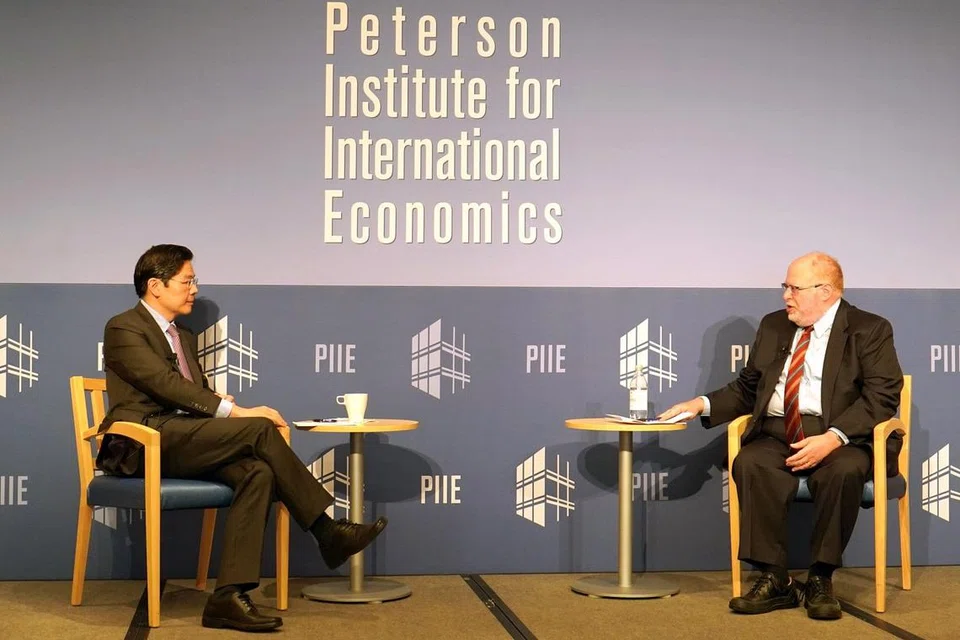 SUKAR BENDUNG CHINA: Akan semakin sukar untuk Amerika membendung China, kata Encik Lawrence Wong dalam dialog anjuran Institut Peterson bagi Ekonomi Antarabangsa di Washington DC yang dipengerusikan presiden institut itu, Dr Adam Posen. - Foto KEMENTERIAN KEWANGAN