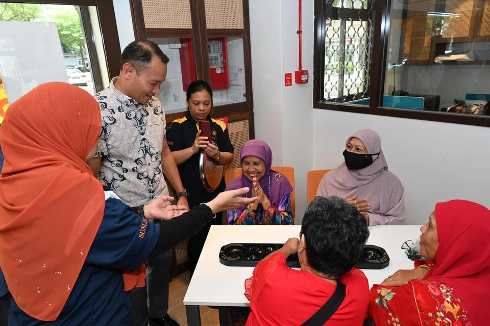 Encik Mohd Fahmi Aliman beramah-tamah bersama warga emas di Pusat Kesejahteraan Mental Sunlove yang sedang bermain congkak, yang dapat membantu mereka kekal aktif dari segi mental dan fizikal. 