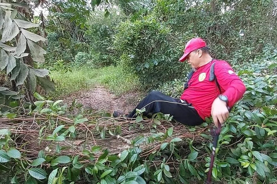 RENTAS HALANGAN: Ustaz Raja Muzaffar Shah merentas pokok besar tumbang yang menghalang jalan denai. - Foto ihsan RAJA MUZAFFAR SHAH
