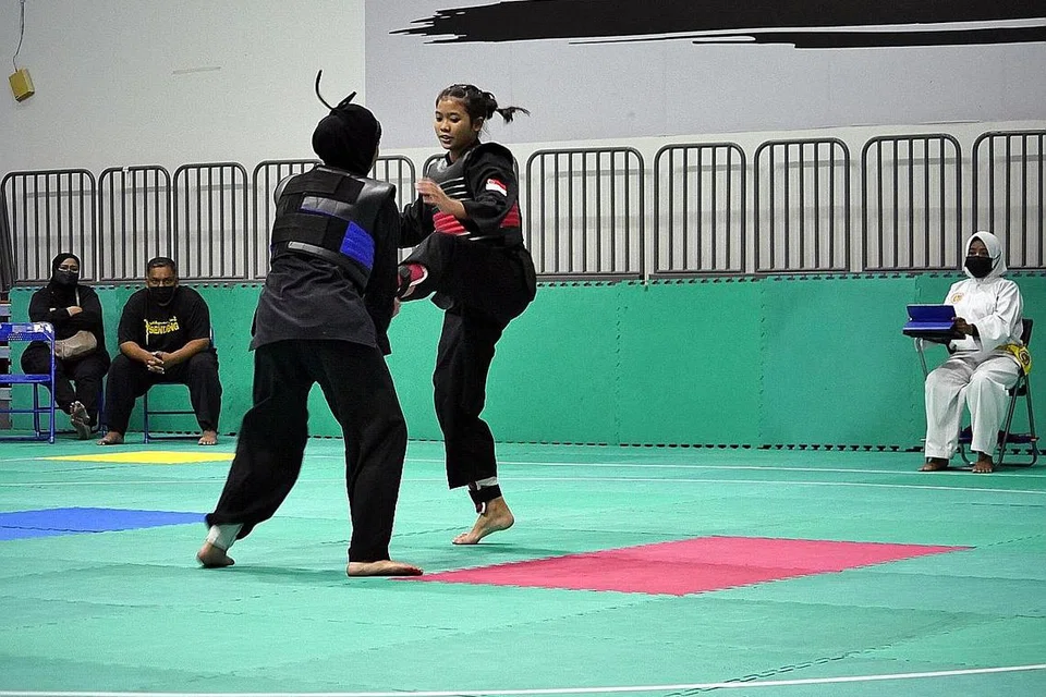 'CABARAN RAMADAN': Pesilat negara, Rifqah Mursyidah Mistam (tali pinggang merah), menguji kemampuan menentang Anis Khaliesah Mohammed Rafi, daripada Perguruan Sendeng Belalang, (tali pinggang biru). - Foto PERSISI