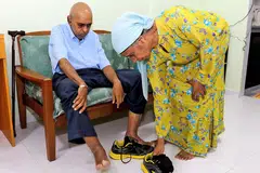 KASIH IBU: Cik Asma (kanan) menyimpan tabung amanah dengan SNTC sebagai usaha memastikan keperluan anaknya, Encik Sulaiman, yang berkeperluan khas, akan diurus, selepas beliau meninggal dunia. - Foto SHAHRIYA YAHAYA