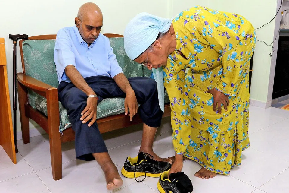 KASIH IBU: Cik Asma (kanan) menyimpan tabung amanah dengan SNTC sebagai usaha memastikan keperluan anaknya, Encik Sulaiman, yang berkeperluan khas, akan diurus, selepas beliau meninggal dunia. - Foto SHAHRIYA YAHAYA