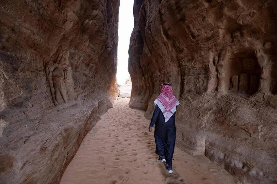 A man walks around Ancient Nabataean carved tombs at the archaeological site of al-Hijr (Hegra), near the northwestern Saudi city of al-Ula. The government is making travel to the country simpler in its bid to attract more tourists. - Photo AFP)