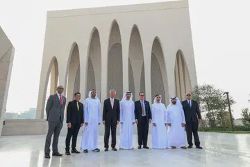 LAMBANG PERPADUAN: Encik Lee (empat dari kiri) bergambar di hadapan masjid yang merupakan sebahagian daripada kompleks antara agama Abrahamic Family House di Abu Dhabi yang melambangkan nilai perpaduan. (Dari kiri) Dr Janil Puthucheary, Dr Maliki Osman, dan Dr Tan See Leng (empat dari kanan).