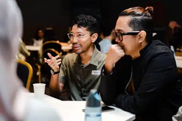BELAJAR DARI YANG LEBIH BERPENGALAMAN: Encik Syahmi Mansor (kiri) timba pengetahuan dalam interaksi dengan pakar industri technologi 