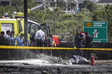 NAHAS BAWA MAUT: Seorang penunggang motosikal juga terkorban setelah pesawat terhempas ke jalan raya pada Khamis.
