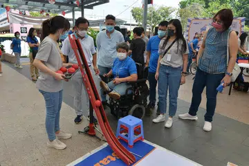 PUPUK KESEDARAN: Anggota Parlimen (AP) Encik Chong Kee Hiong (GRC Bishan-Toa Payoh) (dua dari kiri) dengan beberapa wakil Persatuan Distrofi Otot Singapura (MDAS) mencuba sukan Boccia di sebuah pesta pupuk kesedaran tentang penyakit Distrofi Otot di Kelab Masyarakat Bishan semalam. - Foto MDAS