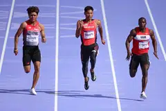 Marc Louis (kiri) ketika bertanding dalam pusingan kelayakan awal lari pecut lelaki 100 meter di Stade de France pada 3 Ogos.