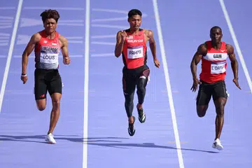Marc Louis (kiri) ketika bertanding dalam pusingan kelayakan awal lari pecut lelaki 100 meter di Stade de France pada 3 Ogos.