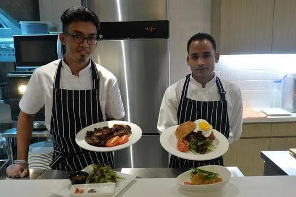 MASAK DI DEPAN MATA: Pelanggan boleh melihat cef Encik Fakhruli Islam Mohd Shah (kiri) dan Encik Mohd Imran menyediakan sajian stik di restoran berkonsep terbuka di The Royals Steakhouse di Jalan Pisang.