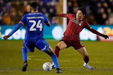 TERIKAT: Takumi Minamoto (kanan) cuba melepasi pemain Shrewbury Town Ethan Ebanks-Landell dalam perlawanan pusingan keempat Piala FA. - Foto REUTERS
