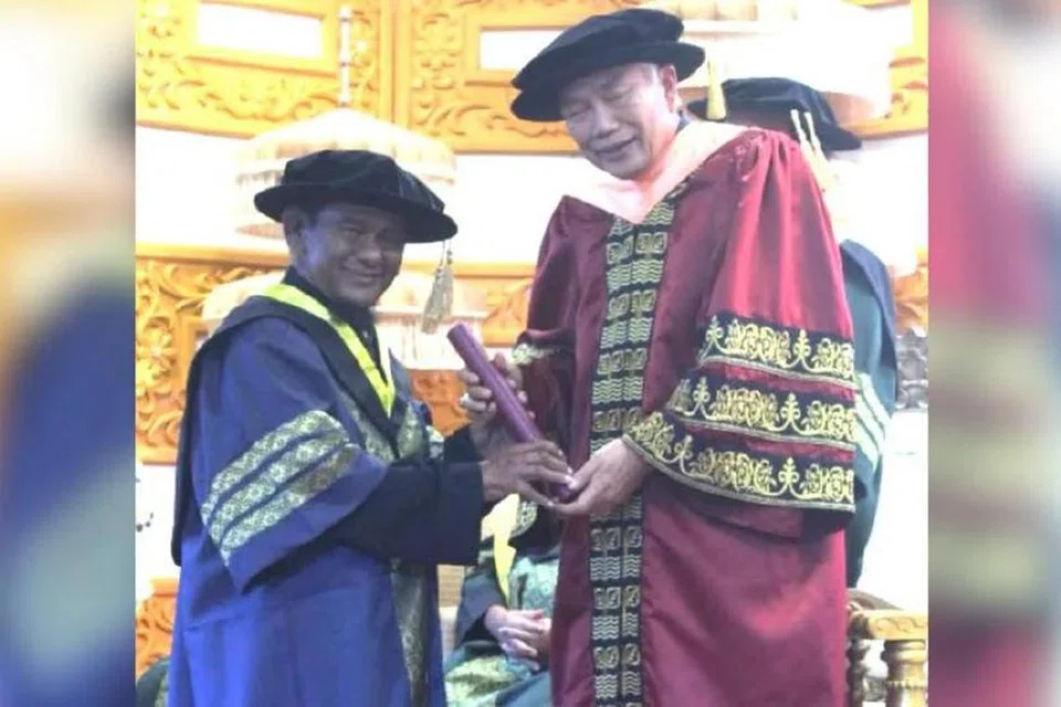 Ebby Yus (kiri) menerima Anugerah Ijazah Kehormat Doktor Persilatan daripada Presiden Akademi Persilatan Sedunia, Profesor Dr Zainal Abidin Sakom, di Melaka pada 8 September.