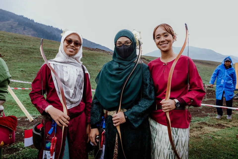 Cik Zayanah Hamis (kiri), pemanah tradisional Singapura bersama atlet antarabangsa lain.