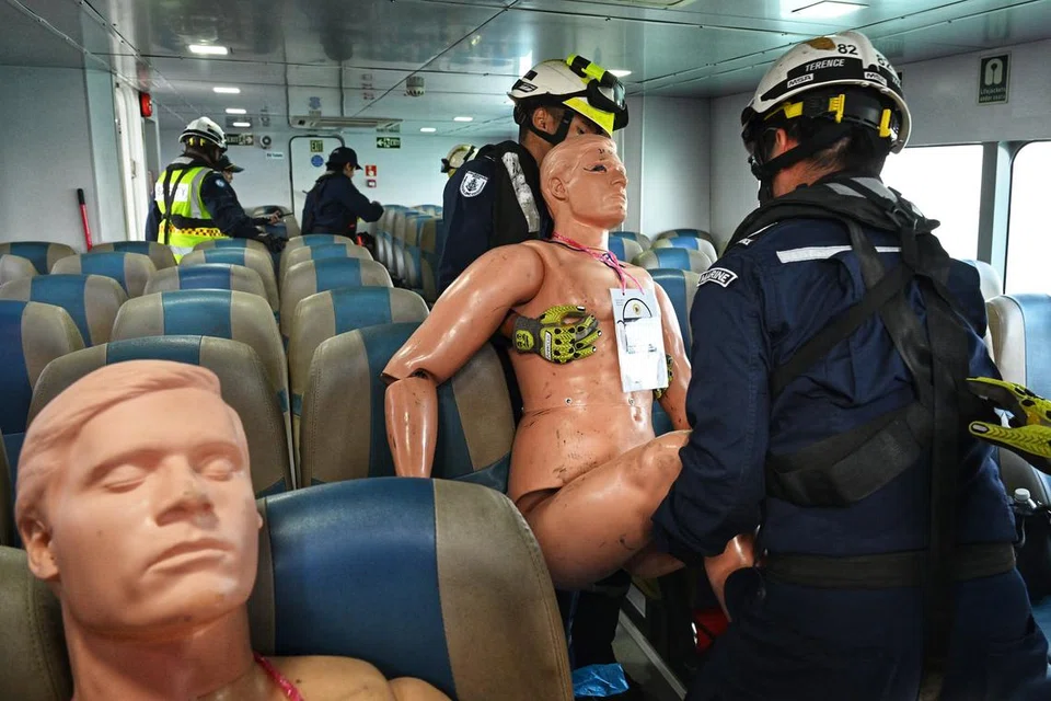 Pegawai SCDF dirakam memindahkan mangsa dari atas feri ke kawasan yang selamat.