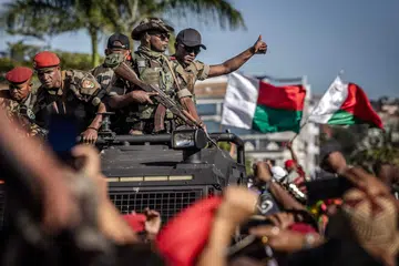 Para anggota unit tentera elit menyambut gembira sambutan para penunjuk perasaan dalam protes menuntut peletakan jawatan Presiden Andry Rajoelina di Antananarivo, pada 14 October 2025. 