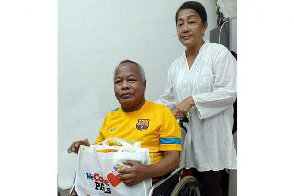 JAGA KESIHATAN: Encik Abbas Zainal (berkerusi roda) dan adiknya, Cik Asiah Zainal, kini dapat menghela nafas lega selepas menerima pelitup muka AIR+ Smart dan WeCare PAcks daripada Encik Lee Hsien Loong semalam. - Foto TAUFIK A. KADER